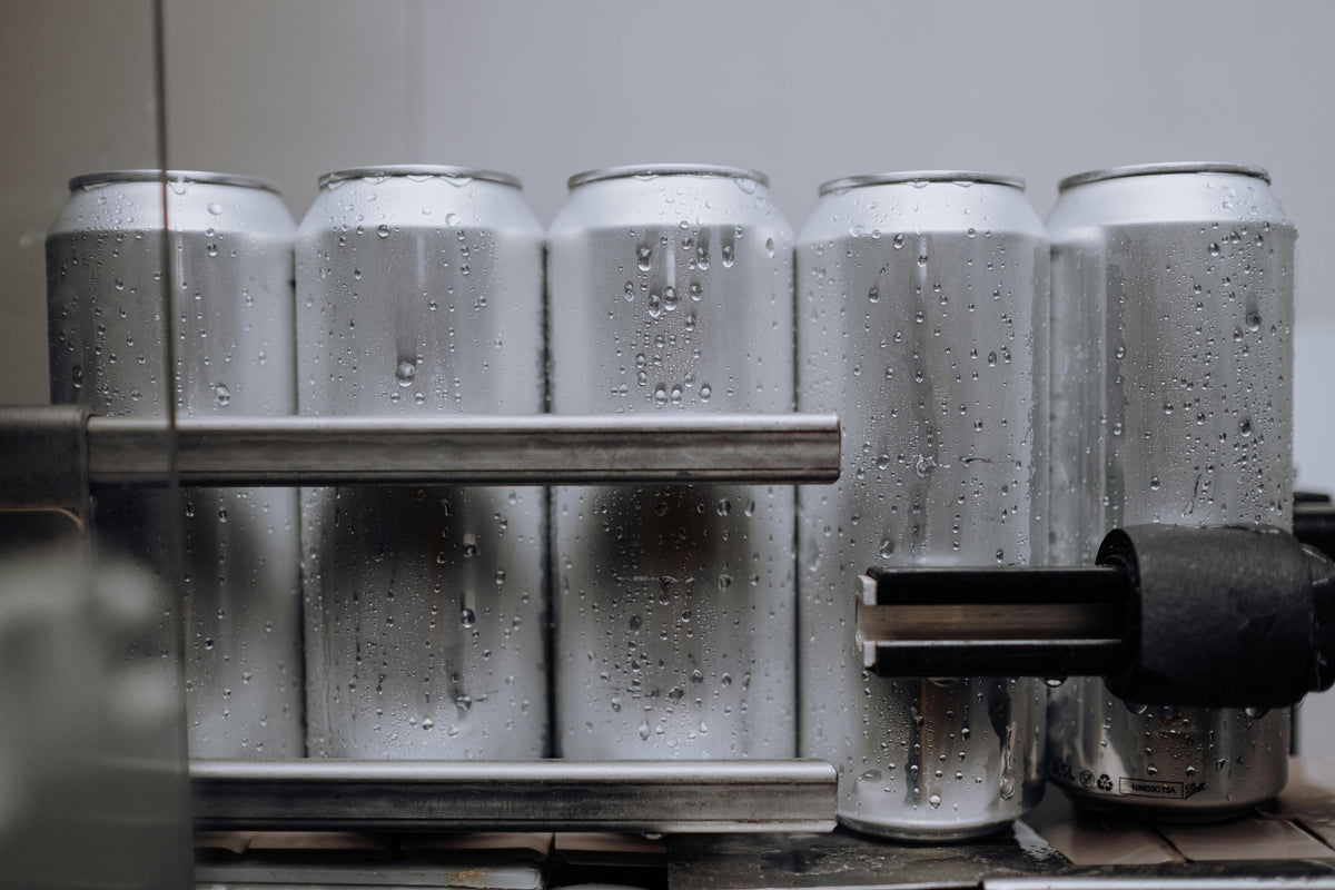 Aluminum cans on a production line representing hydrogen water can technology