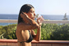 Woman drinking water outdoors representing hydration research and facts