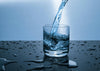 Water pouring into a glass representing hydrogen-rich hydration science